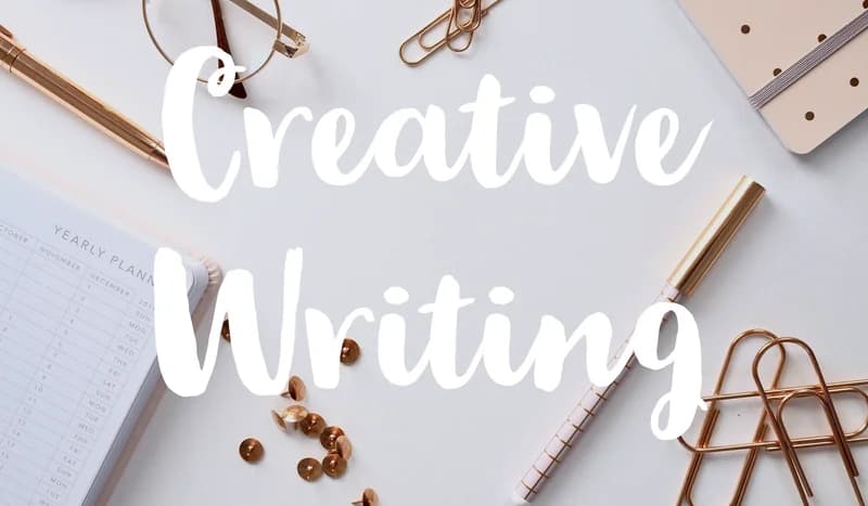 Creative writing — a planner and pens on a desk.